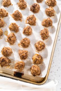 Cooling homemade oven-baked meatballs on the kitchen counter.