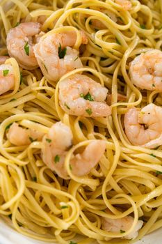 Serving homemade shrimp scampi with linguine pasta garnished with fresh parsley.