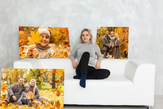 woman holding a photo of autumn, canvas.