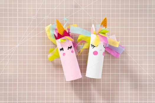 Flat lay. Making a unicorn out of the toilet paper roll and craft paper.