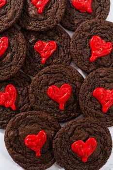 Freshly baked chocolate cookies with chocolate hearts for Valentine's Day.