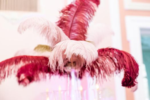 details of home interior design. A wall of pink feathers and a vase of feathers