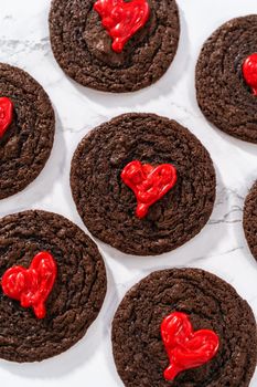 Freshly baked chocolate cookies with chocolate hearts for Valentine's Day.