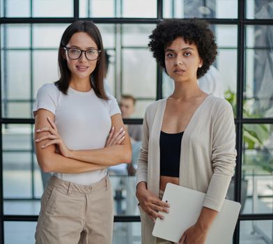 Businesswomen Having Informal Meeting In Modern Office