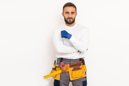 Man builder in a robe, overalls on a white background. Isolate, copy space.