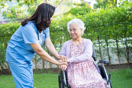 Doctor help and care Asian senior or elderly old lady woman patient sitting on wheelchair at nursing hospital ward, healthy strong medical concept