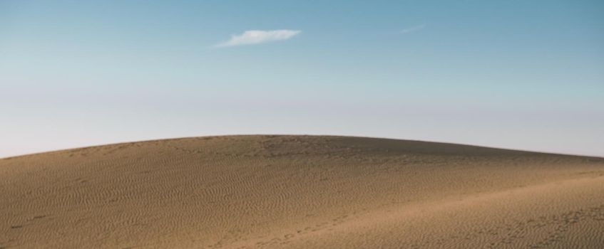 Sand dunes beach of Maspalomas Gran Canaria during sunrise. Beautiful layers of sand dunes in the desert of Gran Canaria