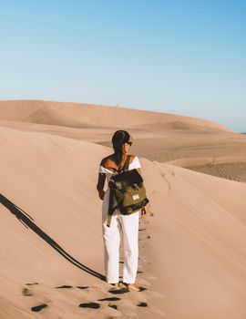 young woman at the dessert of Maspalomas sand dunes Gran Canaria during vacation at the Canary Islands. in Spain, Gran Canaria sand dunes