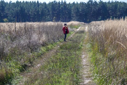 Young boy playing in a field. boy running across the field with his hands in different directions. children fun games. nature leisure with children concept.