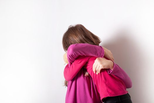 Happy and healthy young little girls hugging and smiling. Best friend kids and children friendship, equality, positive mental health wellness concept