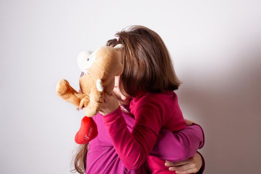 Happy and healthy young little girls hugging and smiling. Best friend kids and children friendship, equality, positive mental health wellness concept