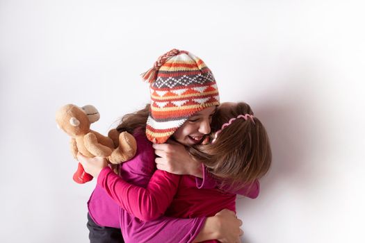 Happy and healthy young little girls hugging and smiling. Best friend kids and children friendship, equality, positive mental health wellness concept