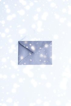 Greetings, postal service and online newsletter concept - Winter holiday blank paper envelopes on marble with shiny snow flatlay background, love letter or Christmas mail card design