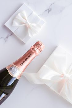 Celebration, drink and branding concept - Champagne bottle and gift box on marble, New Years, Christmas, Valentines Day or wedding holiday present and luxury product packaging for beverage brand