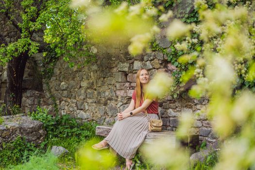 Woman tourist walks through the old town of Bar in Montenegro. Happy tourist walks in the mountains. Suburbs of the city of Bar, Montenegro, Balkans. Beautiful nature and landscape.
