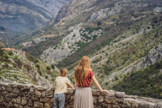 Mom and son tourists walks through the old town of Bar in Montenegro. Happy tourist walks in the mountains. Suburbs of the city of Bar, Montenegro, Balkans. Beautiful nature and landscape.