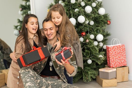 military father and children near christmas tree.