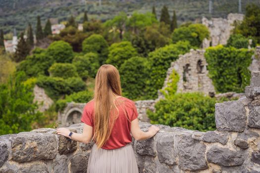 Woman tourist walks through the old town of Bar in Montenegro. Happy tourist walks in the mountains. Suburbs of the city of Bar, Montenegro, Balkans. Beautiful nature and landscape.