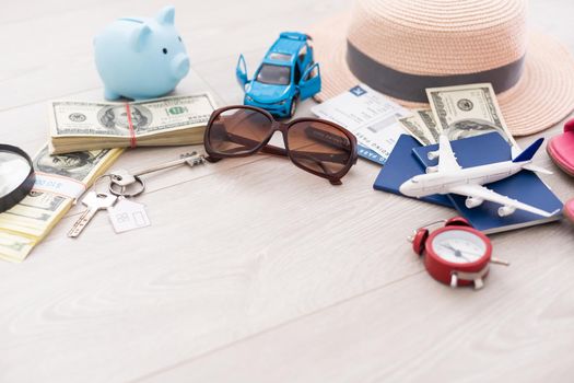 dollars, piggy bank, alarm clock, hat, glasses. Time to go on holiday. Things for summer trip