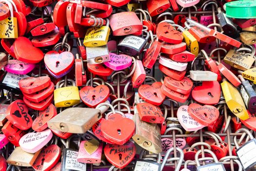 Verona, Italy - June 2022: background of heart-shaped locks on a wall, symbol of love forever