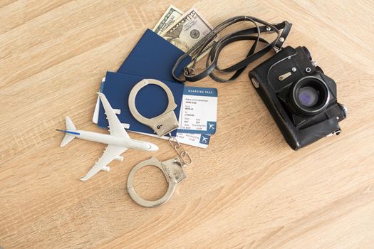 passport, tickets, toy plane, handcuffs