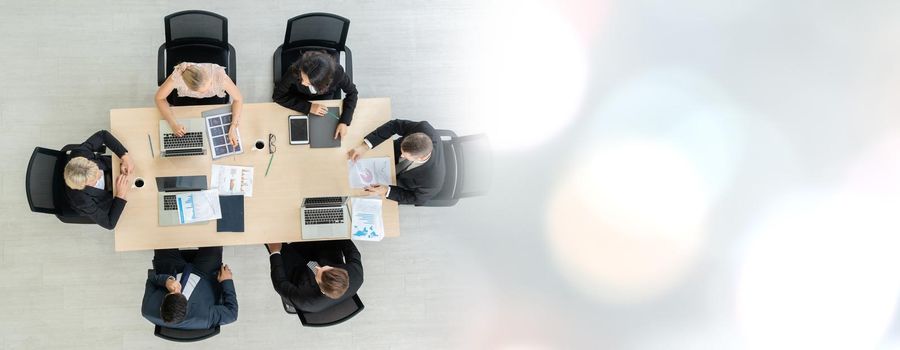 Business people group meeting shot from top widen view in office . Profession businesswomen, businessmen and office workers working in team conference with project planning document on meeting table .