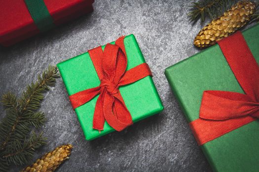 Gift box on a black background. New Year's gift top view. Red and green boxes. Surprise on the table.