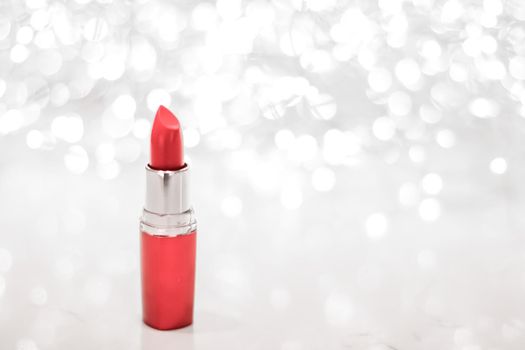 Cosmetic branding, sale and glamour concept - Coral lipstick on silver Christmas, New Years and Valentines Day holiday glitter background, make-up and cosmetics product for luxury beauty brand