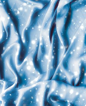 Winter fashion, shiny fabric and glamour style concept - Magic holiday blue soft silk flatlay background texture with glowing snow, luxury beauty abstract backdrop