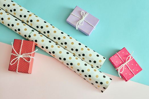 Different colored gift box on color background.
