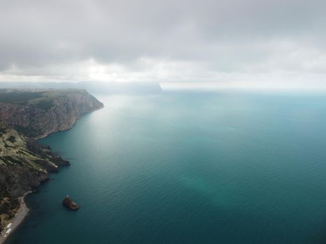 Aerial panoramic view of beautiful sunset above sea. Beautiful seascape. Sun glare, small waves on the water surface. Evening. Horizon. Nobody. No people. Copy space. Never-ending beauty of nature