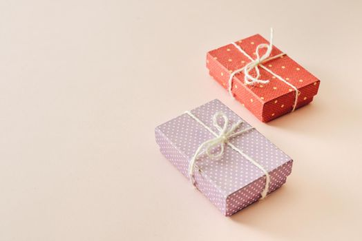 Colorful gifts over pink background, flat lay style with copy space