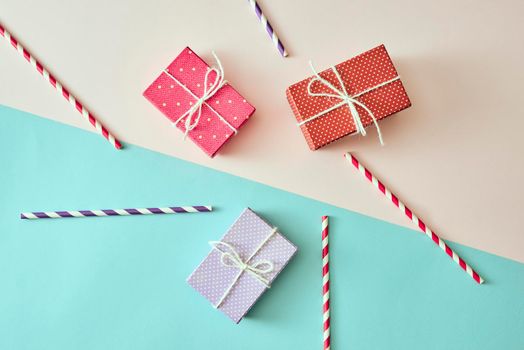 present boxes with ribbon on pink canvas background