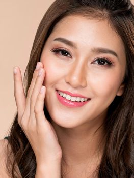 Closeup portrait of ardent young girl with healthy clear skin and soft makeup looking at camera and posing beauty gesture. Cosmetology and beauty concept.