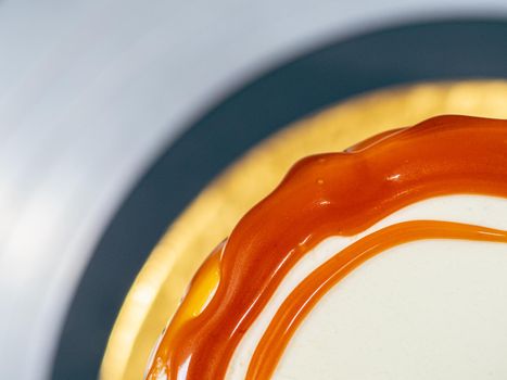 professional baker decorating a chocolate and cream cake with salty caramel