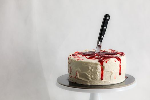 Bleeding monster cake with knife on cake stand