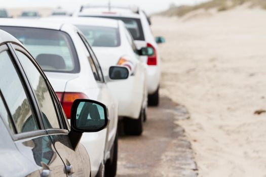 White cars parked on the side of the road.