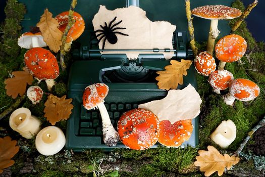 Fly agaric mushrooms are located on a retro typewriter and around on green moss. Mockup. Space for text.