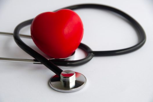 Stethoscope with heart shape on white background. Copy space and health concept.
