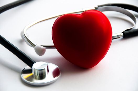 Stethoscope with heart shape on white background. Copy space and health concept.