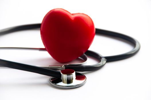 Stethoscope with heart shape on white background. Copy space and health concept.