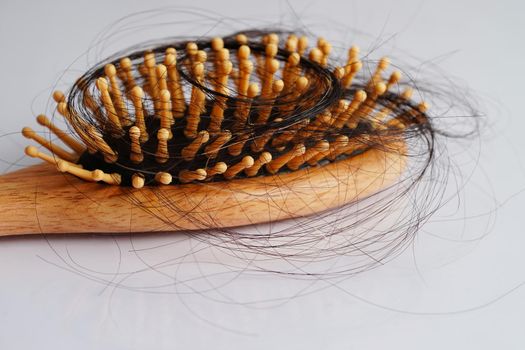 Hair loss fall with comb brush isolated on white background.