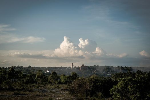 Atmosphere panorama cumulus white clouds over buddhist temple statue. Dramatic Sky Sunset Meditation background.