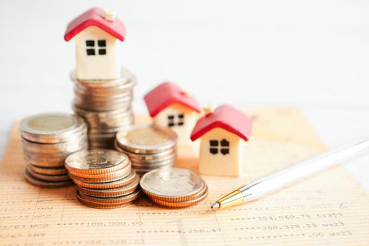 House on stack of coins, Investment property finance concept.