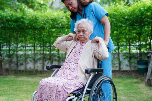 Asian elderly woman disability patient exercise on wheelchair with doctor in park, medical concept.