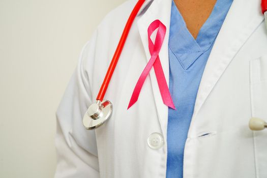 Asian woman doctor with pink ribbon, World Breast Cancer Day at October.