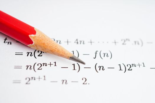 Pencil on mathematic formula exercise test paper in education school.