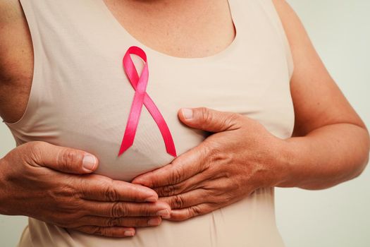 Asian woman with pink ribbon, World Breast Cancer Day at October.