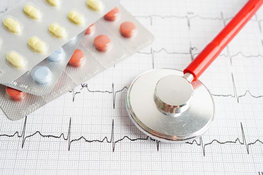 Stethoscope on electrocardiogram (ECG) with drug, heart wave, heart attack, cardiogram report.