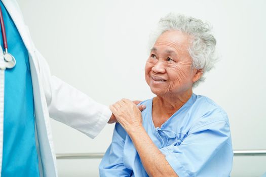 Doctor holding hands Asian elderly woman patient, help and care in hospital.